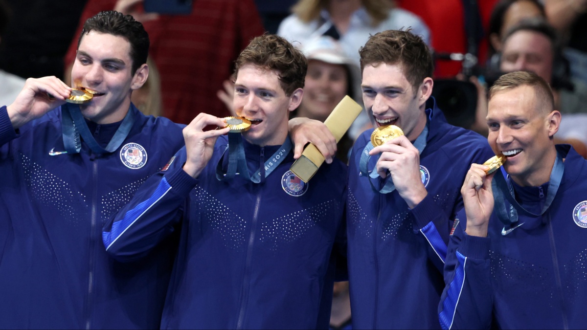 Why Do Olympic Swimmers Wear Winter Coats? Explained