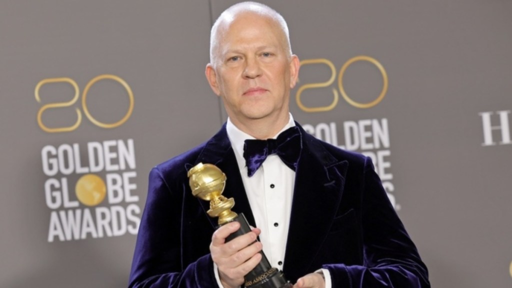 Ryan Murphy holds a Golden Globe.