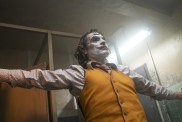 Joaquin Phoenix spreads his arms out in Joker.