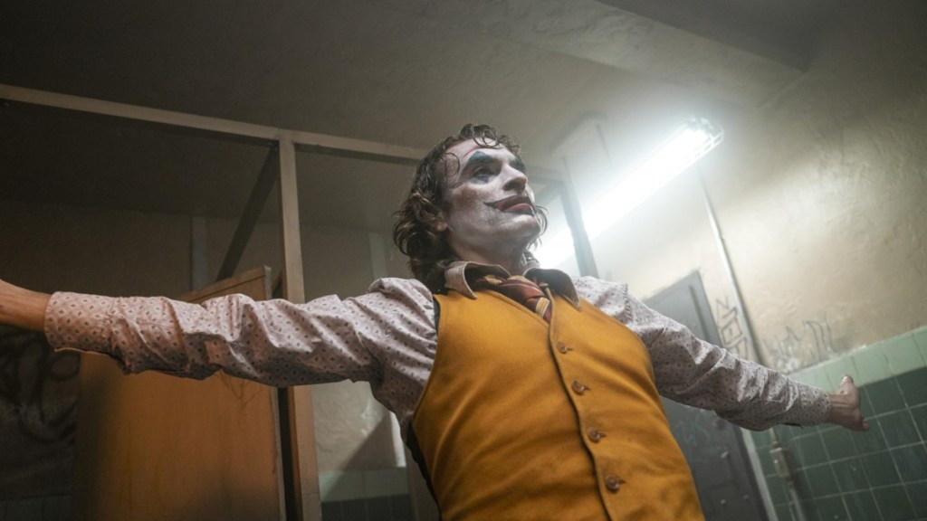 Joaquin Phoenix spreads his arms out in Joker.