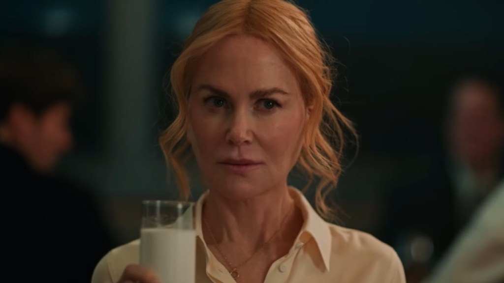 Nicole Kidman holds a glass of milk in Babygirl.