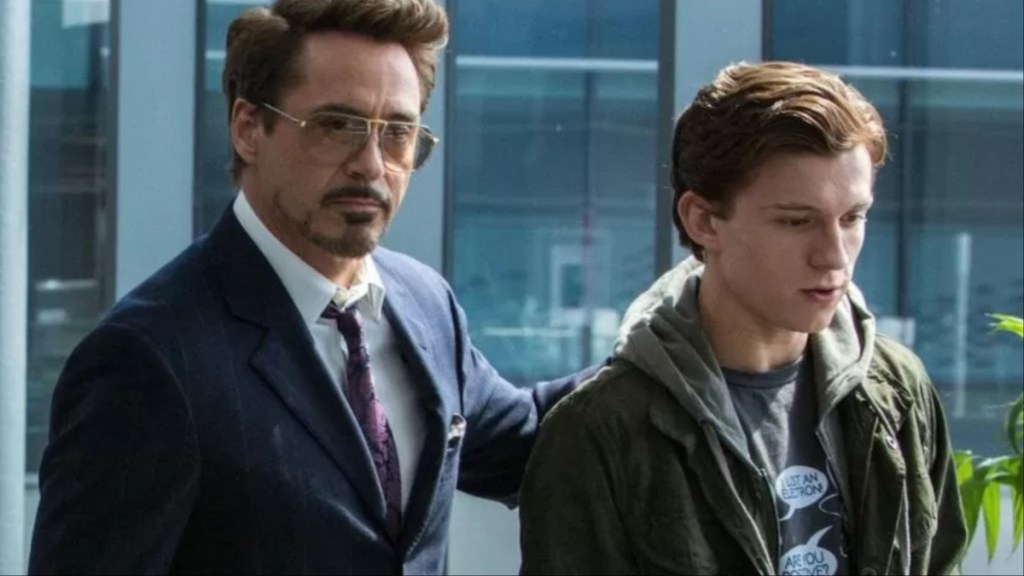 Robert Downey Jr. puts his hand on Tom Holland’s shoulder.