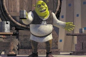 Shrek holds up a glass and stands in Shrek.