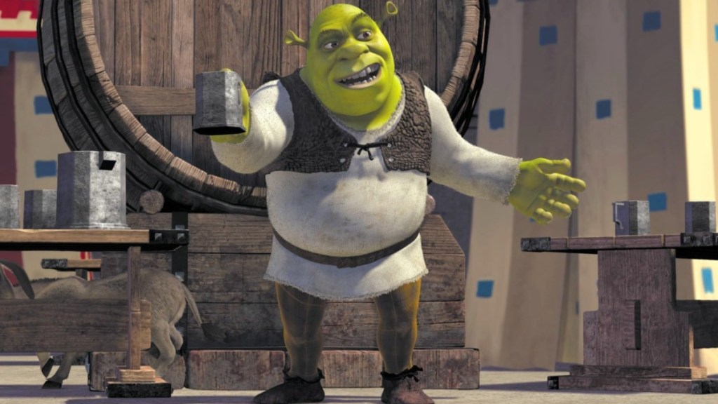 Shrek holds up a glass and stands in Shrek.