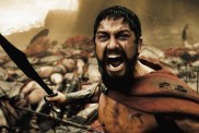 Gerard Butler holds a sword in 300.