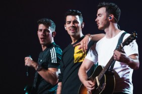 The Jonas Brothers sing onstage in Happiness Continues.