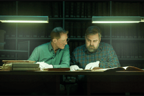 Photo from Netflix's The Breakthrough: Two men sit at a desk, examining genealogical records as they work to solve a cold case.