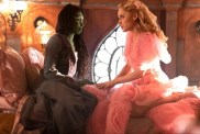 Elphaba and Glinda sit down and stare at each other in Wicked: Part I.