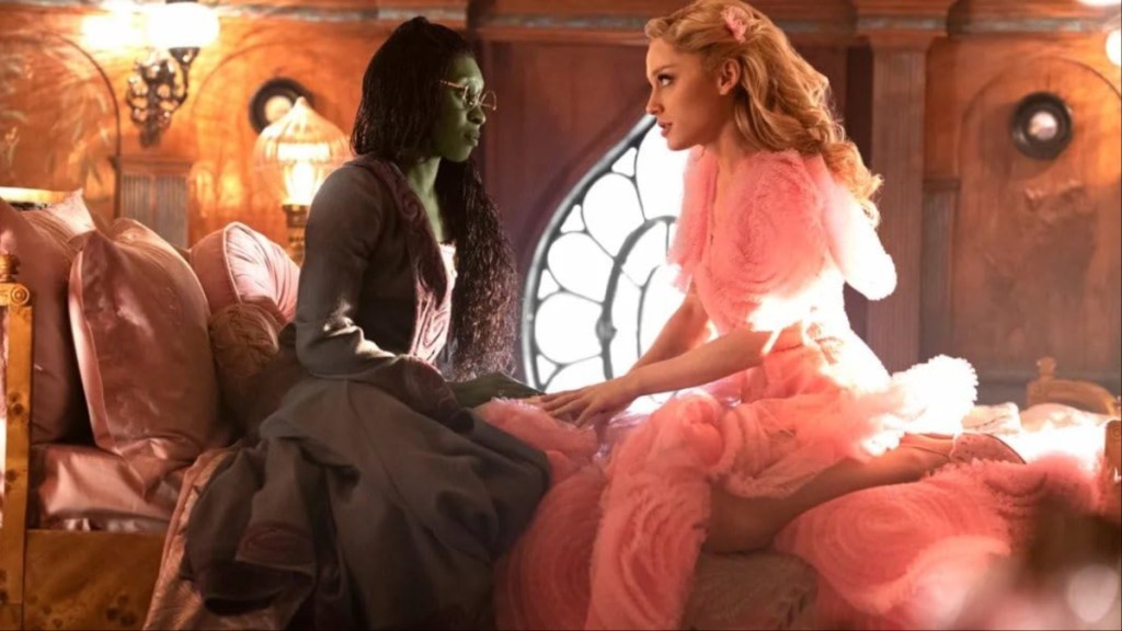 Elphaba and Glinda sit down and stare at each other in Wicked: Part I.